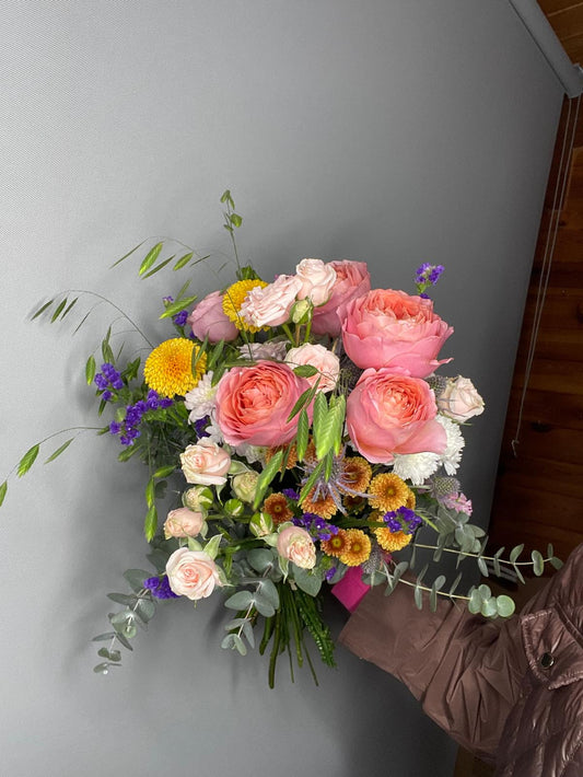 Éclat Rosé — ramo con rosas coral, cardo azul y flores naranjas otoñales